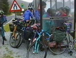 The group takes shelter from the rain in the Lochailort bus shelter